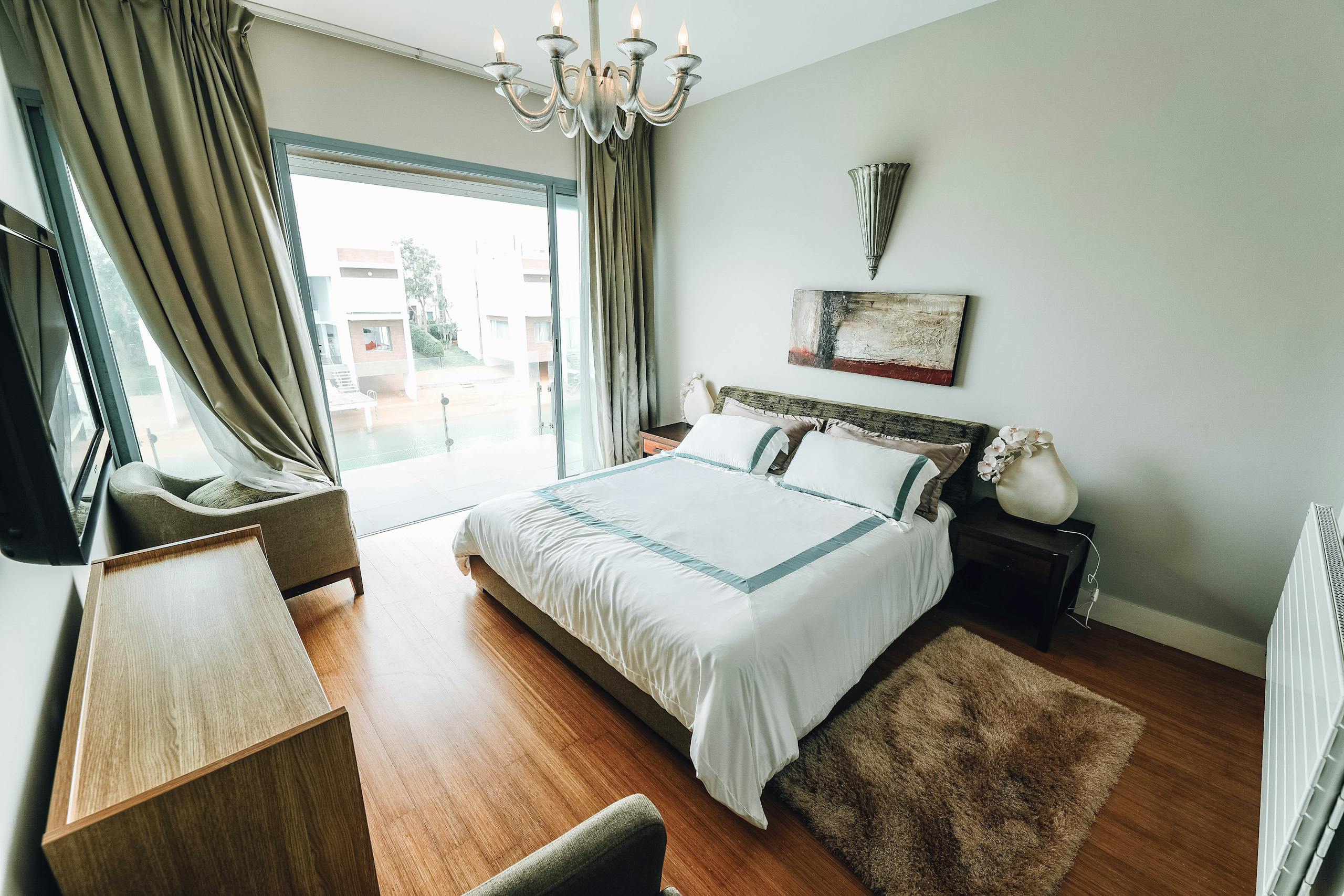Elegant modern bedroom with stylish decor and natural light, perfect for interior design inspiration.